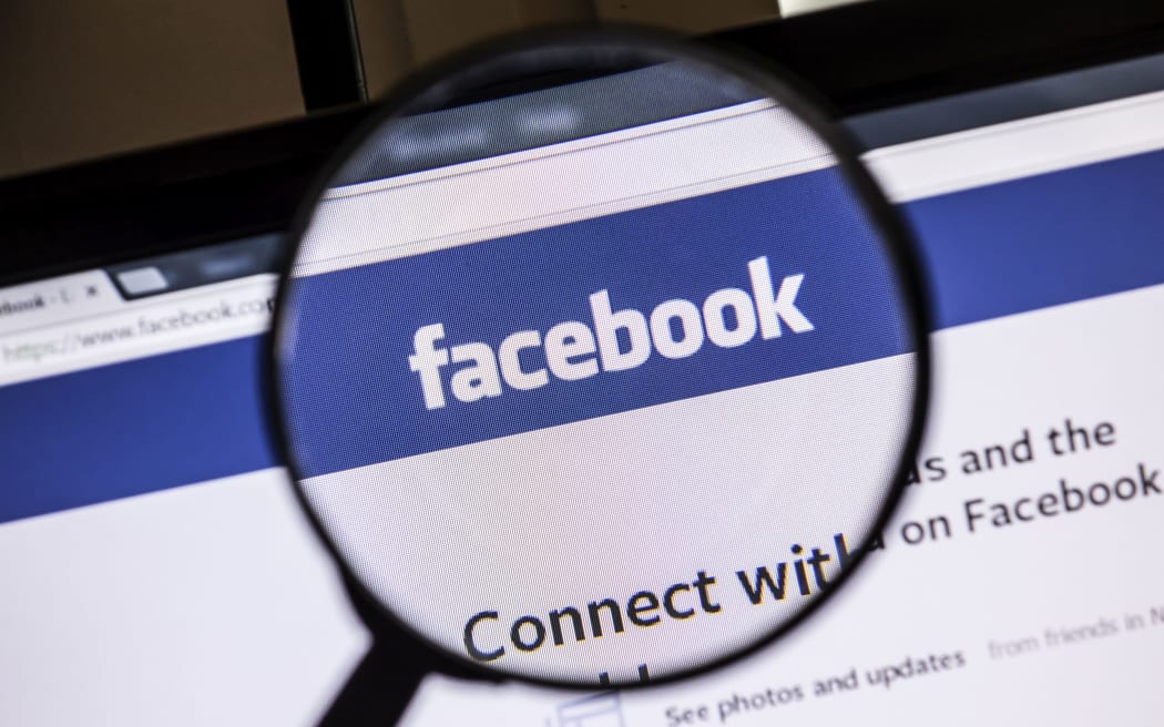 Facebook website under a magnifying glass