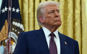 US President Donald Trump listens as the new US Secretary of Health and Human Services Robert F. Kennedy Jr., speaks after being sworn in at the Oval Office of the White House in Washington, DC, on February 13, 2025. (Photo by ANDREW CABALLERO-REYNOLDS / AFP)