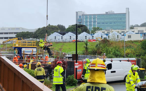 A worker being taken to hospital after being trapped under a steel pole at the Central Interceptor site in Sandringham, Auckland.