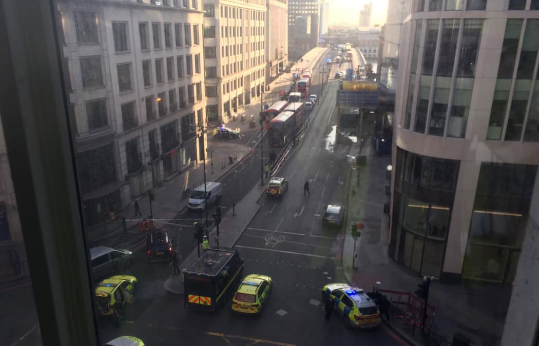 A handout picture shows members of the police and emergency services setting up a cordon on London Bridge following an incident in central London on November 29, 2019.