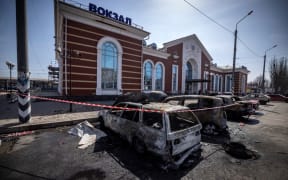 Calcinated cars are pictured outside a train station in Kramatorsk, eastern Ukraine, that was being used for civilian evacuations, after it was hit by a rocket attack killing at least 35 people, on April 8, 2022.