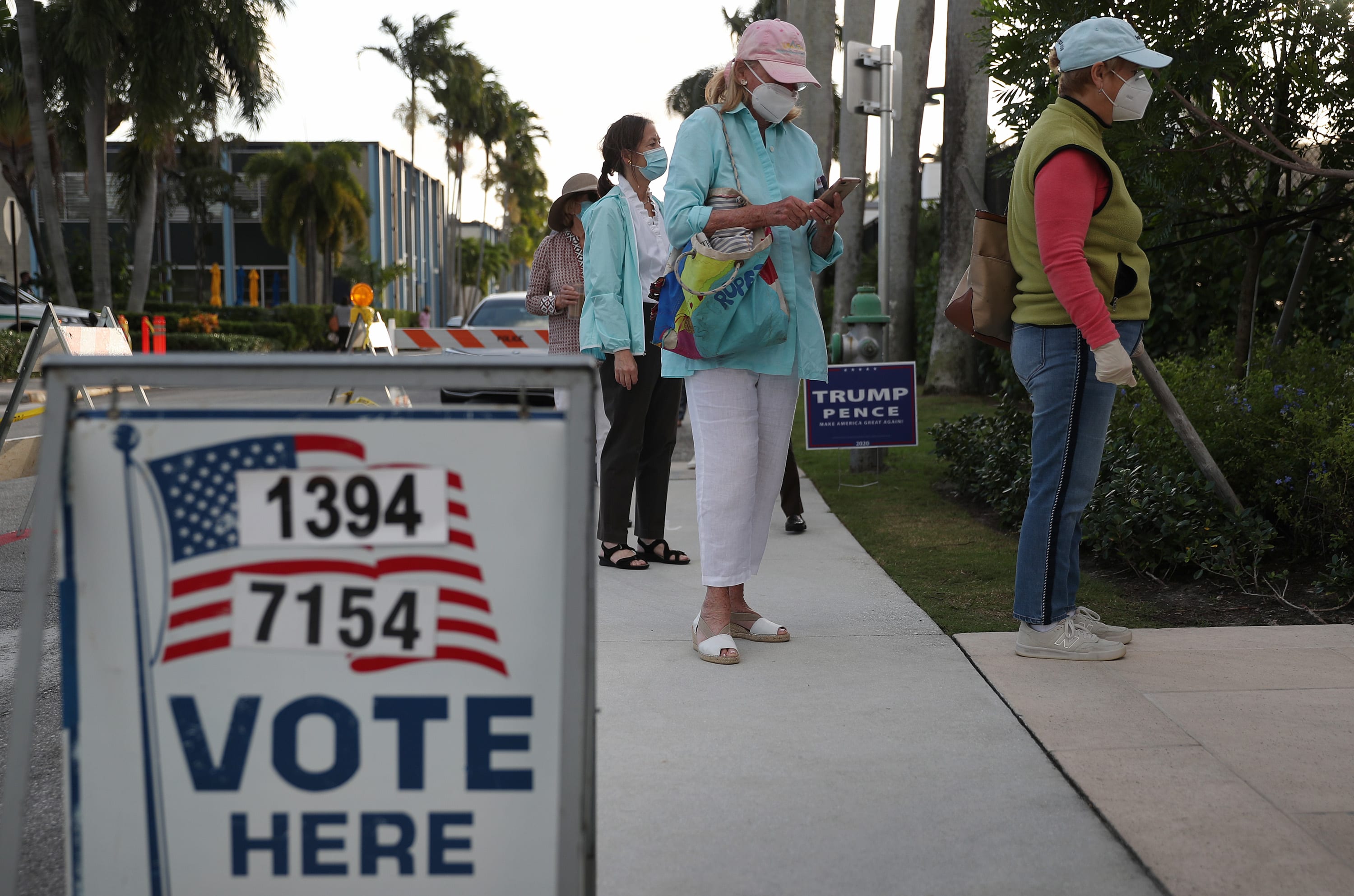 People stand in line to vote at the Morton and Barbara Mandel Recreation Center on November 03, 2020 in Palm Beach, Florida.