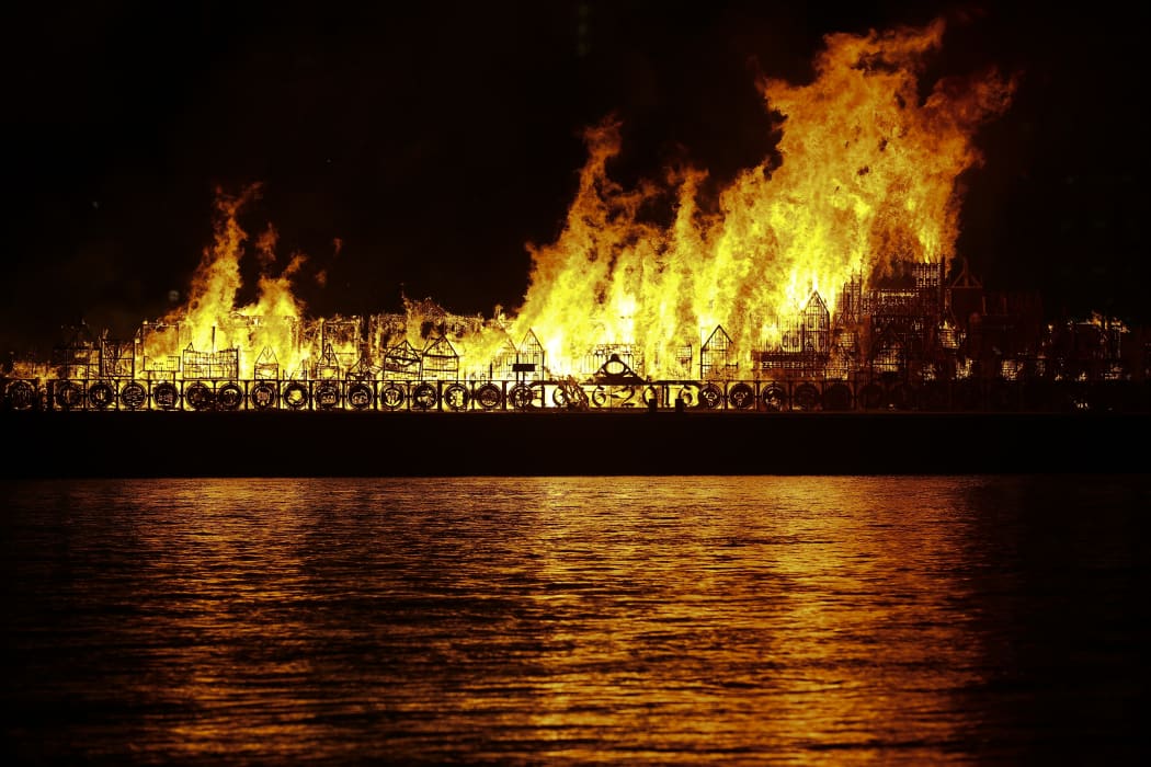 Alt text:
    A replica of 17th-century London on a barge floating on the river Thames is set ablaze in an event to mark the 350th anniversary of the Great Fire of London.