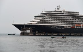 Fishing boats are pictured next to the Westerdam cruise ship in Sihanoukville on February 19, 2020.