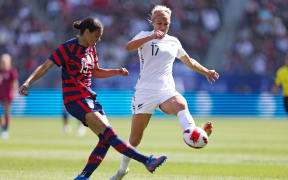 Football Ferns Hannah Wilkinson defends against Alana Cook of the USA.
