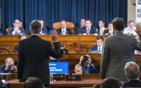 Charge d'Affaires at the US embassy in Ukraine Bill Taylor (left) and Deputy Assistant Secretary of State for Europe and Eurasia George Kent (right) are sworn in to testify before the House Permanent Select Committee on Intelligence hearing on the impeachment inquiry into President Trump