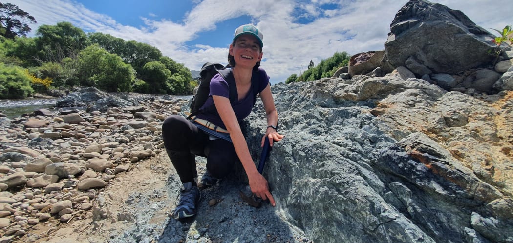 Dr. Carolyn Boulton next to the slipping zone on part of the Wellington Fault