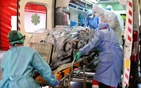 Medical staff transfer from the Garbagnate Milanaise hospital a patient with Covid-19 in a bio-containment stretcher for infectious diseases to Varese hospital.