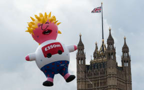 Boris Blimp balloon depicting Tory leadership hopeful Boris Johnson flies next to the Houses of Parliament ahead of anti-Brexit Yes to Europe, no to Boris demonstration on 20 July, 2019 in London, England.