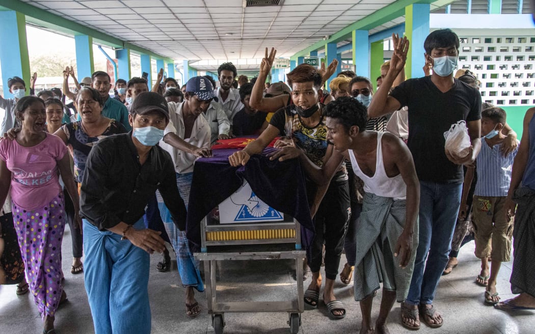 Family members and relatives attend the funeral ceremony of 13 year-old Sai Wai Yan, who was shot dead while playing outside his house in Yangon, Myanmar on March 28, 2021.