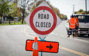 A road closed detour sign.