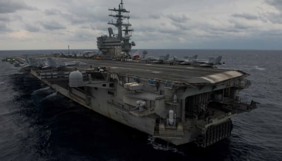 This image released by the US Navy shows forward-deployed aircraft carrier and flagship of Carrier Strike Group Five, USS Ronald Reagan (CVN 76).