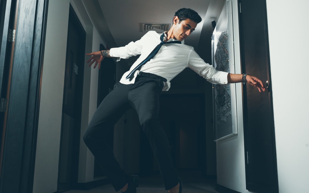 man in business attire dancing