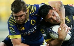 Marvin Karawana of Wellington is tackled by Michael Collins of Otago.