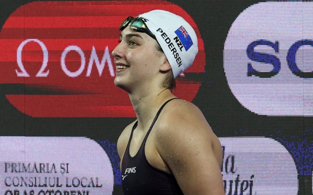 Zoe Pedersen smiles after winning gold in the women's butterfly final at the junior world swimming championships in Romania, 23 Aug, 2025. Photo: Ian MacNicol.