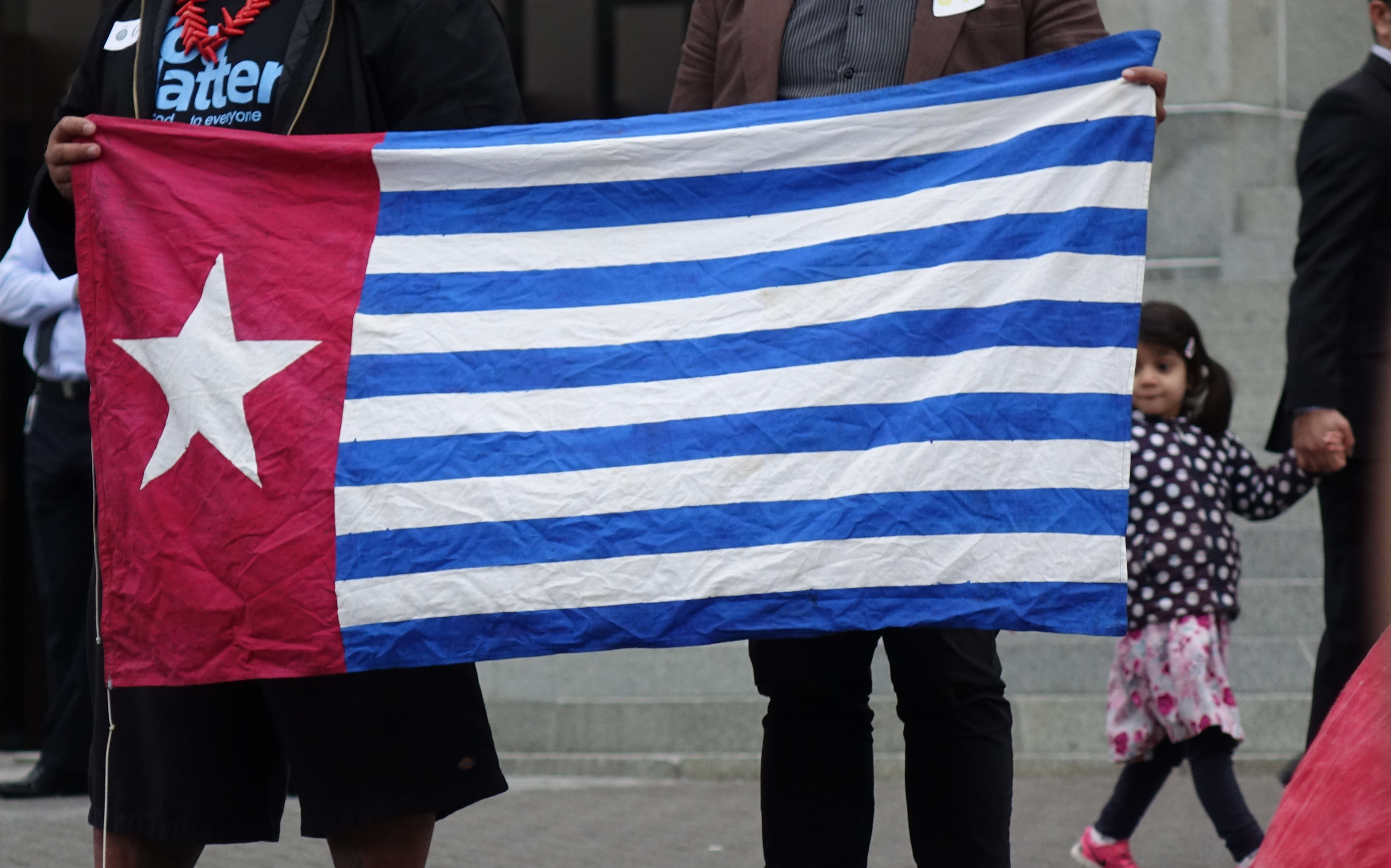David Tua and Jerome Mika hold the West Papuan Morning Star flag outside New Zealand's parliament, 25 August, 2016.
