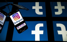 (FILES) this file photo taken on October 05, 2020 in Toulouse, southwestern France, shows logos of US social networks Facebook and Instagram on the screens of a tablet and a mobile phone.