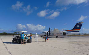 Godfrey Capelle, Connielynn Paul and Benjamin Thomas with a US Army official on arrival at the Kwajalein airport