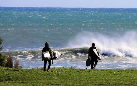 Surfers make their way to Puniho Road surfbreak.