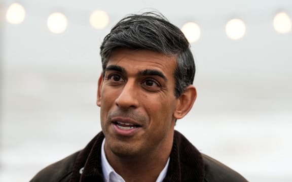 Britain's Prime Minister Rishi Sunak speaks to a TV reporter  during a visit to Clacton-on-Sea, south east England, on October 18, 2023. (Photo by Frank Augstein / POOL / AFP)