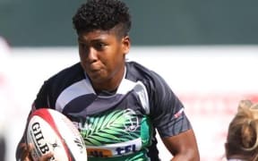 Fiji's Asinate Ifia Savu with the ball against England at the Dubai Sevens.