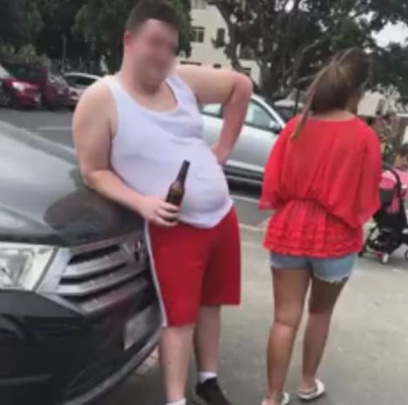 A screengrab from the video posted on social media of a woman challenging the tourists for littering at Takapuna Beach.