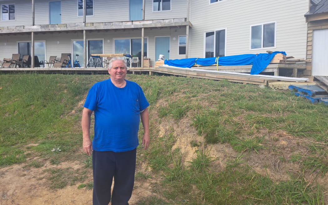 Syd Davies outside the house he is building for his 9 kids on Great Barrier Island.