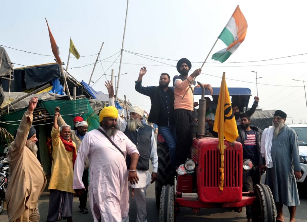 NEW DELHI, INDIA - NOVEMBER 19: Indian Farmers celebrate after Prime Minister Narendra Modi announced the repealing of the three Central farm laws, at Ghazipur Border in New Delhi,India, November. 19, 2021.