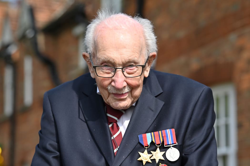 In this file photo taken in April 2020,  British World War II veteran Captain Sir Tom Moore is pictured during a lap of his garden in the village of Marston Moretaine, 50 miles north of London.