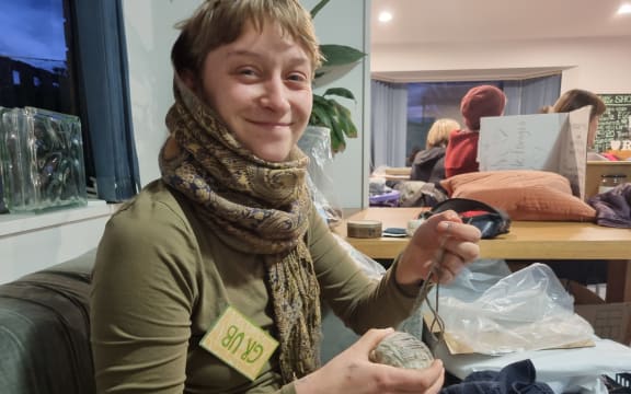Grub McMasters repairing a hole in a rug at Repair Revolution in Christchurch.