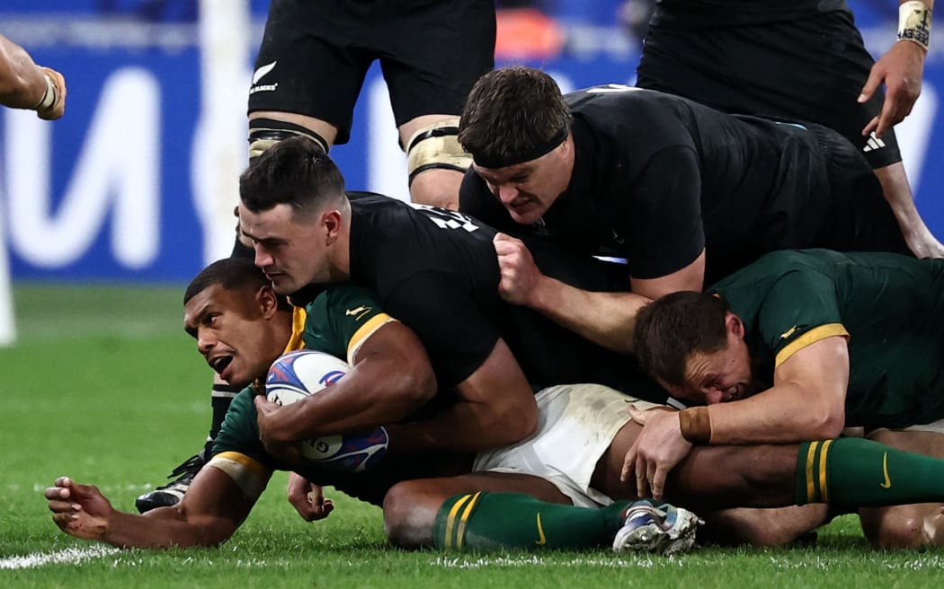 South Africa's full-back Damian Willemse is tackled during the 2023 Rugby World Cup Final between New Zealand and the Springboks at the Stade de France.