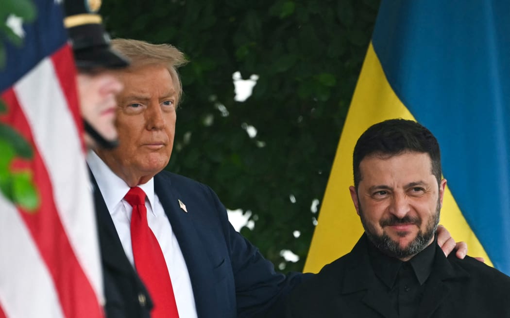 Ukrainian President Volodymyr Zelensky is greeted by US President Donald Trump (L) upon arrival at the White House West Wing in Washington, DC, on August 18, 2025. European leaders join Ukrainian President Volodymyr Zelensky in talks with US President Donald Trump on August 18, as they try to find a way to end Russia's offensive.  The leaders heading to Washington on Monday to appear alongside Zelensky call themselves the "coalition of the willing." (Photo by ANDREW CABALLERO-REYNOLDS / AFP)