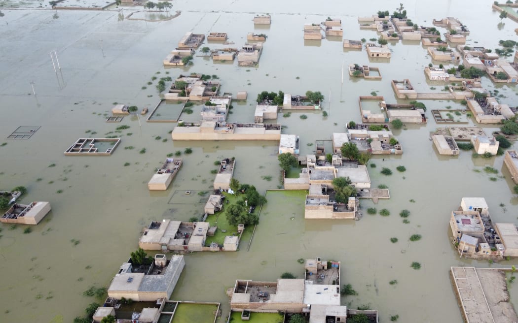An aerial photograph taken on 5 September, 2022 shows flooded residential areas after heavy monsoon rains in Dera Allah Yar, in Pakistan's Balochistan province. Nearly a third of Pakistan is under water - an area the size of the United Kingdom - following months of record monsoon rains that have killed 1,300 people and washed away homes, businesses, roads and bridges.