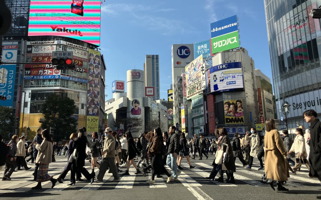 People cross Shibuya Scramble Crossing in Tokyo on Jan. 30, 2024. ( The Yomiuri Shimbun ) (Photo by Kanshiro Sonoda / Yomiuri / The Yomiuri Shimbun via AFP)