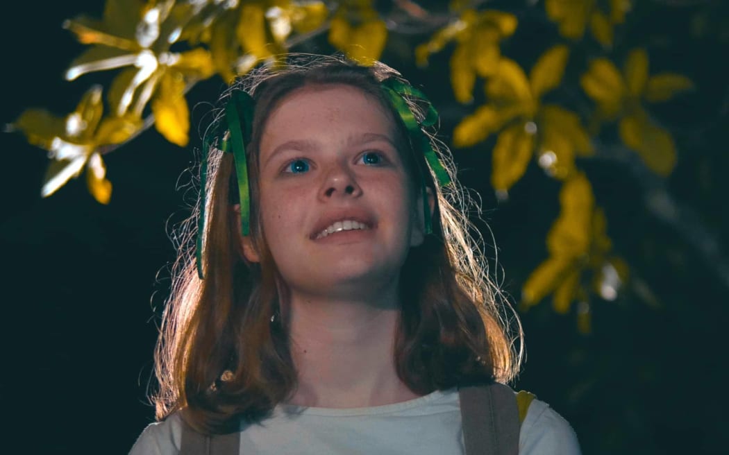 A scene from the short film GOB with a young girl staring out in front of her.