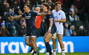 Scotland's scrum-half Ben White (L) celebrates after scoring their third try during the Six Nations international rugby union match between Scotland and England at Murrayfield Stadium in Edinburgh, Scotland on February 14, 2026. (Photo by ANDY BUCHANAN / AFP)