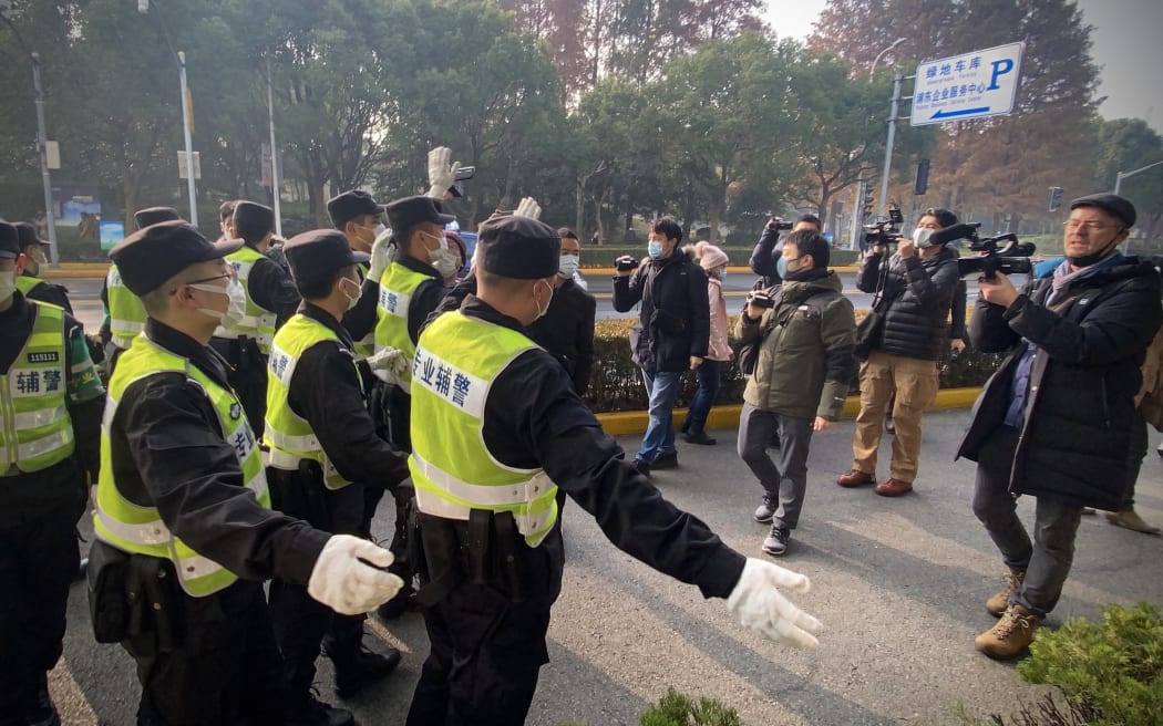 Security officials attempt to stop journalists recording footage outside a Shanghai court as Chinese citizen journalist Zhan Zhang was set for trial on 28 December, 2020.