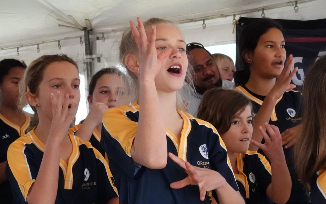 Students of Oromahoe School perform an action song.