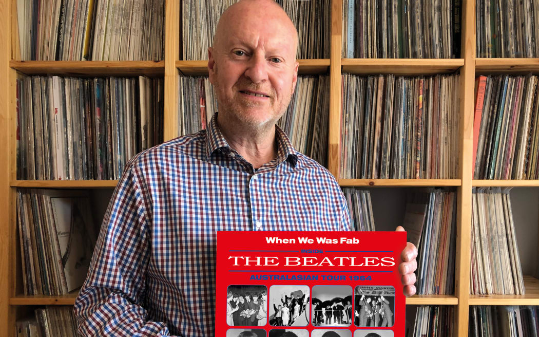 Andy Neill with his book on the Beatles.