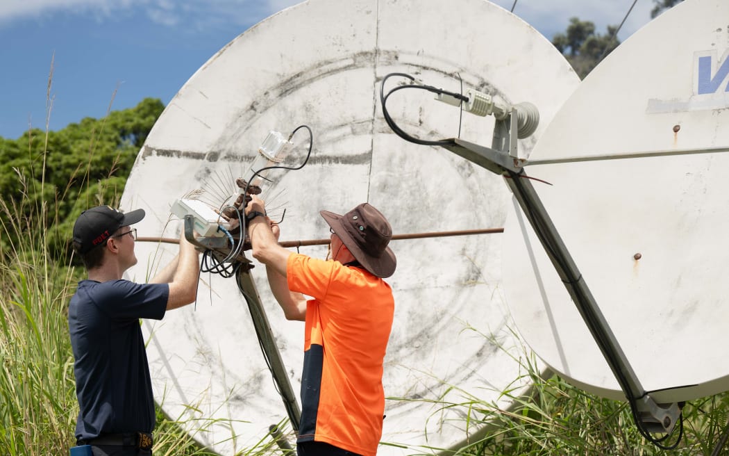 A New Zealand Navy Electronics Technician assists an Earth Sciences NZ technician with monitoring equipment on Raoul Island. February 2026.