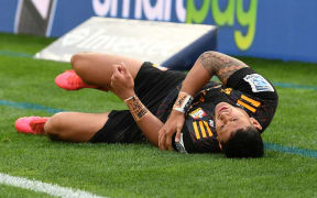 The Chiefs Solomon Alaimalo lies in pain after scoring a try.
