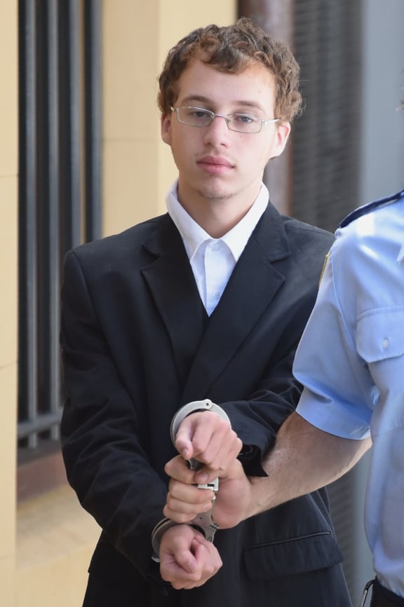 Daniel Kelsall is escorted to a prison transport vehicle at the NSW Supreme Court in Sydney, Wednesday, March 18, 2015. Kelsall, a 21-year-old cleaner, has been found guilty of murder and indecent assault in the stabbing death of Morgan Huxley, at his unit in Sydney's north on September 8, 2013.