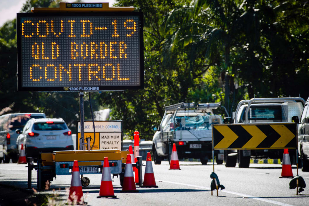 This file photo taken on April 15, 2020 shows a COVID-19 coronavirus sign at a Pacific Highway vehicle checkpoint on the Queensland-New South Wales state border near Coolangatta.