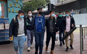 Pro-democracy activist Ventus Lau Wing-hong (third left) is arrested on 6 January 2021 in Hong Kong.