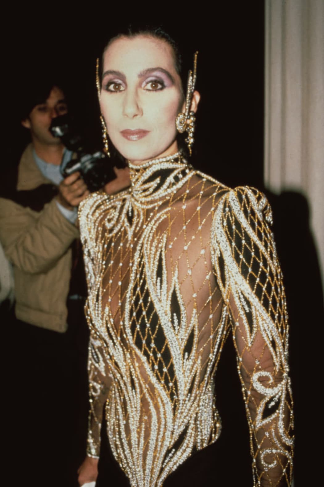 Cher wears a custom sequin black and sheer outfit by Bob Mackie at the Met Gala exhibition of "Costumes of Royal India" in New York City, United States, 9th December 1985.  (Photo by Vinnie Zuffante/Getty Images)