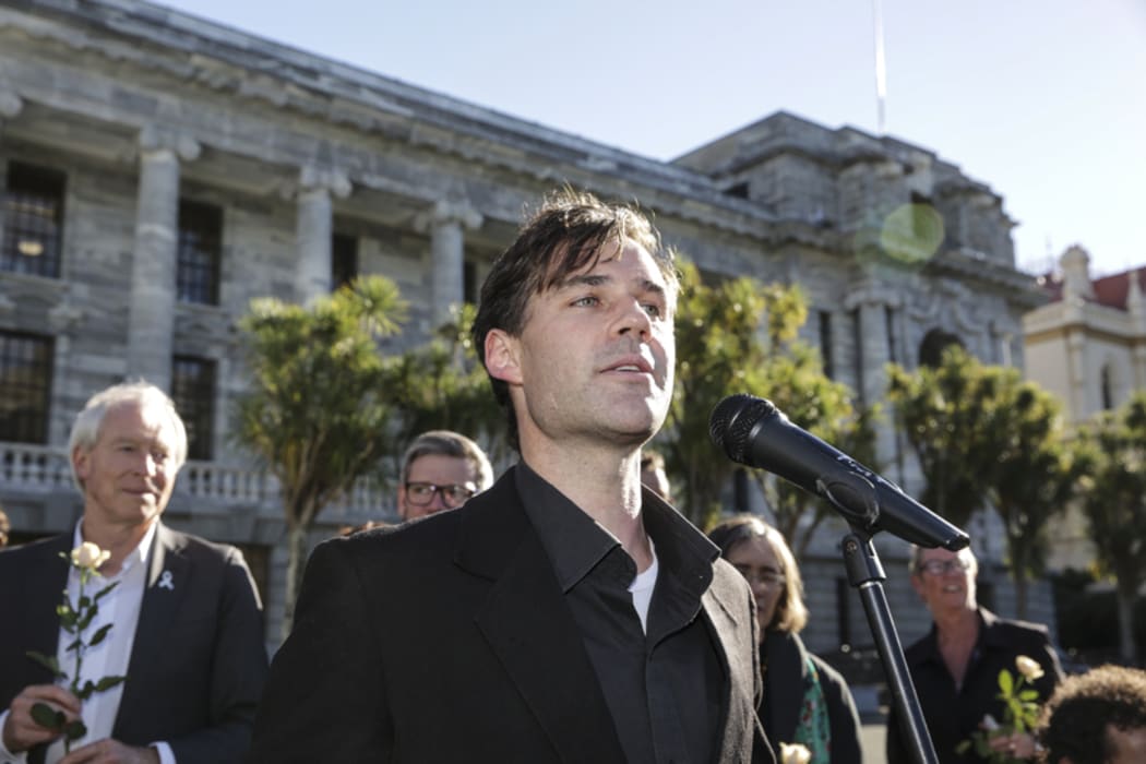 Refugee Quote Protest. Protest organiser Murdoch Stephens speaks to the crowd outside Parliament.