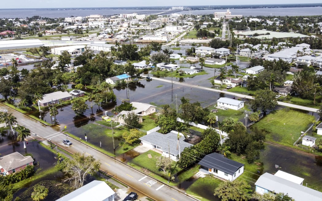 Flooded streets are seen after Hurricane Milton, in Punta Gorda, Florida on October 10, 2024. - Hurricane Milton tore a coast-to-coast path of destruction across the US state of Florida, whipping up a spate of deadly tornadoes that left at least four people dead, but avoiding the catastrophic devastation officials had feared. (Photo by CHANDAN KHANNA / AFP)
