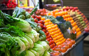 Vegetables and fruit on a market stall.