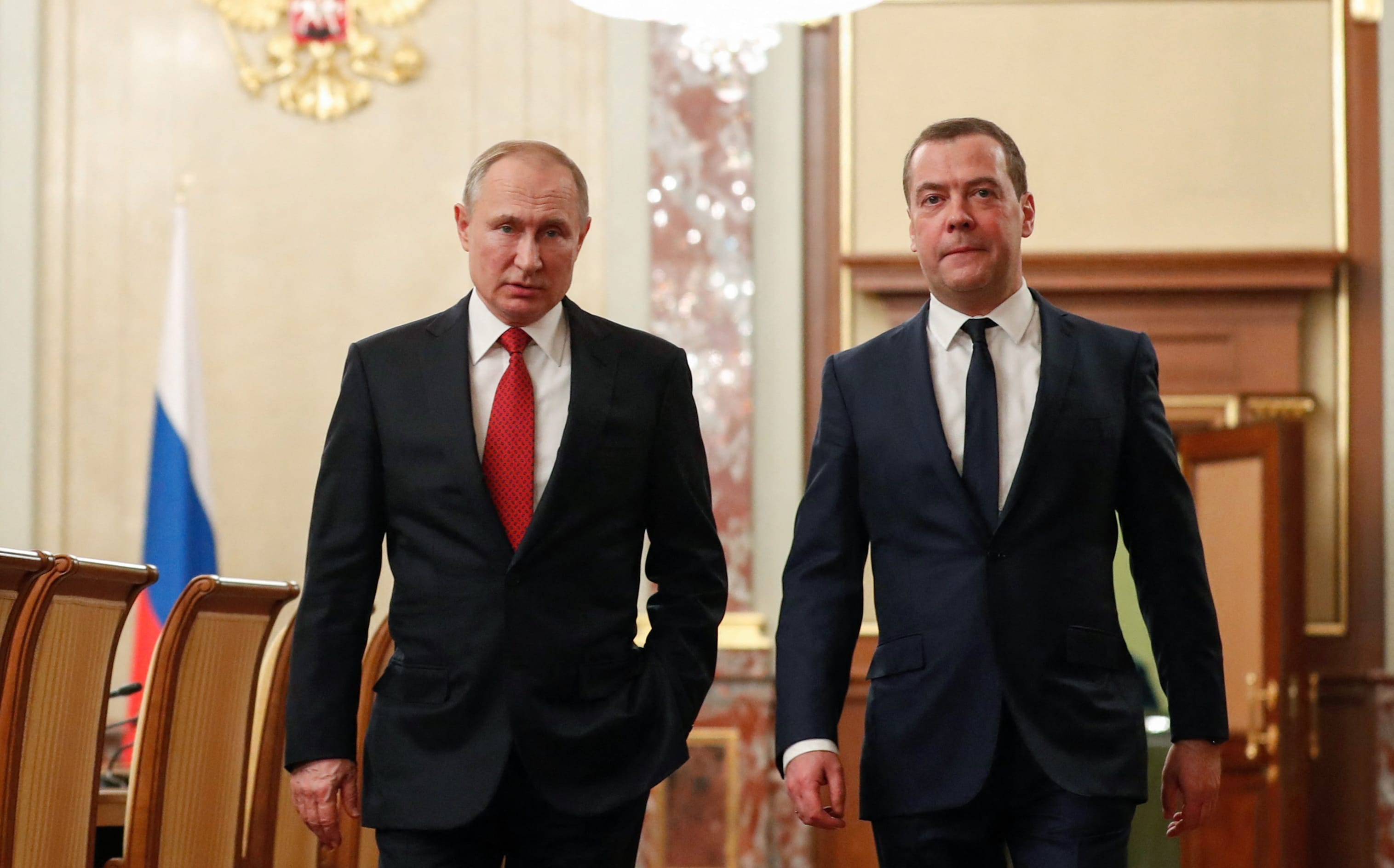 Russian President Vladimir Putin and Russia's Security Council deputy chairman Dmitry Medvedev walk before a meeting with members of the government in Moscow on January 15, 2020.