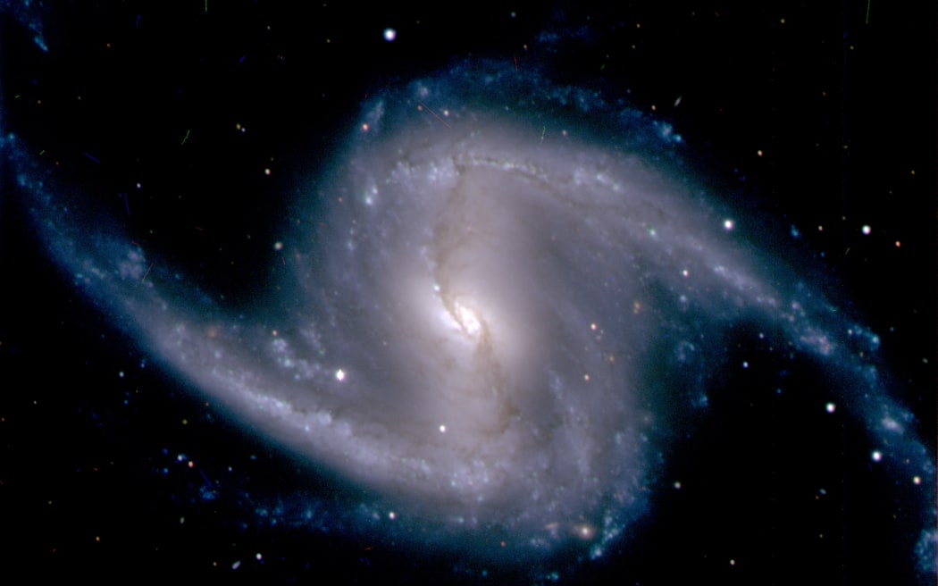 This image courtesy of Fermilab-US Department of Energy (Dark Energy Survey Collaboration) shows a zoomed-in image from the Dark Energy Camera of the barred spiral galaxy NGC 1365, in the Fornax cluster of galaxies, which lies about 60 million light years from Earth. Eight billion years ago, rays of light from distant galaxies began their journey to Earth. That ancient starlight has now found its way to a mountaintop in Chile, where the newly constructed Dark Energy Camera, the most powerful sky-mapping machine ever created, has captured and recorded it for the first time.That light may hold within it the answer to one of the biggest mysteries in physics -- why the expansion of the universe is speeding up.